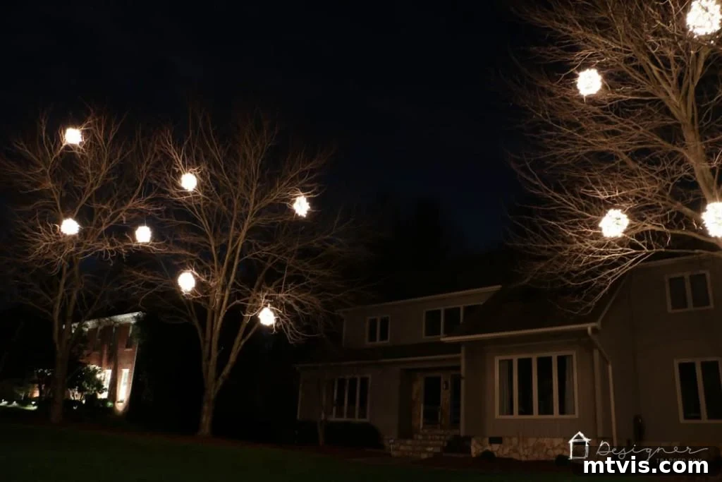 A row of illuminated white Christmas balls creating a festive outdoor ambiance.