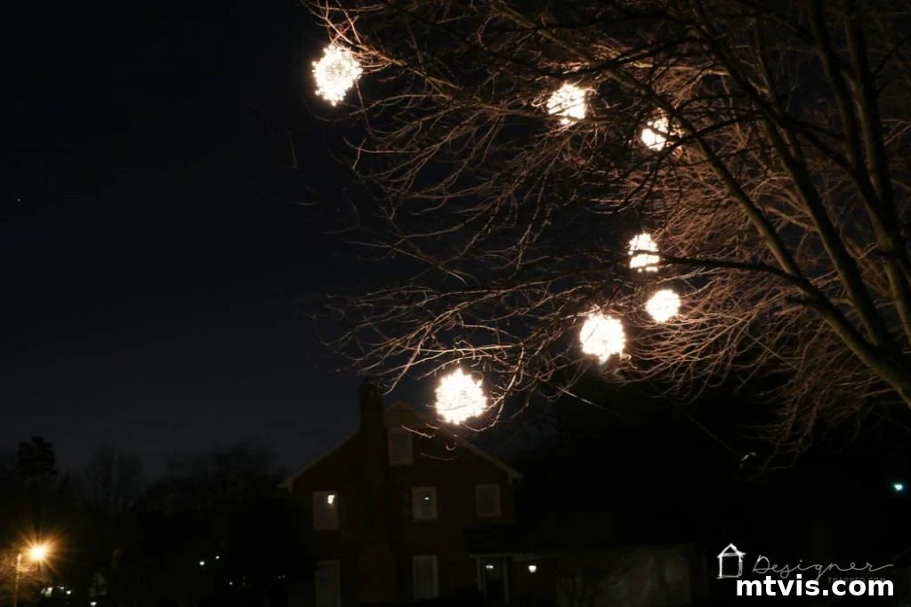 A wide shot of a home's exterior completely transformed by the magic of lighted Christmas balls.