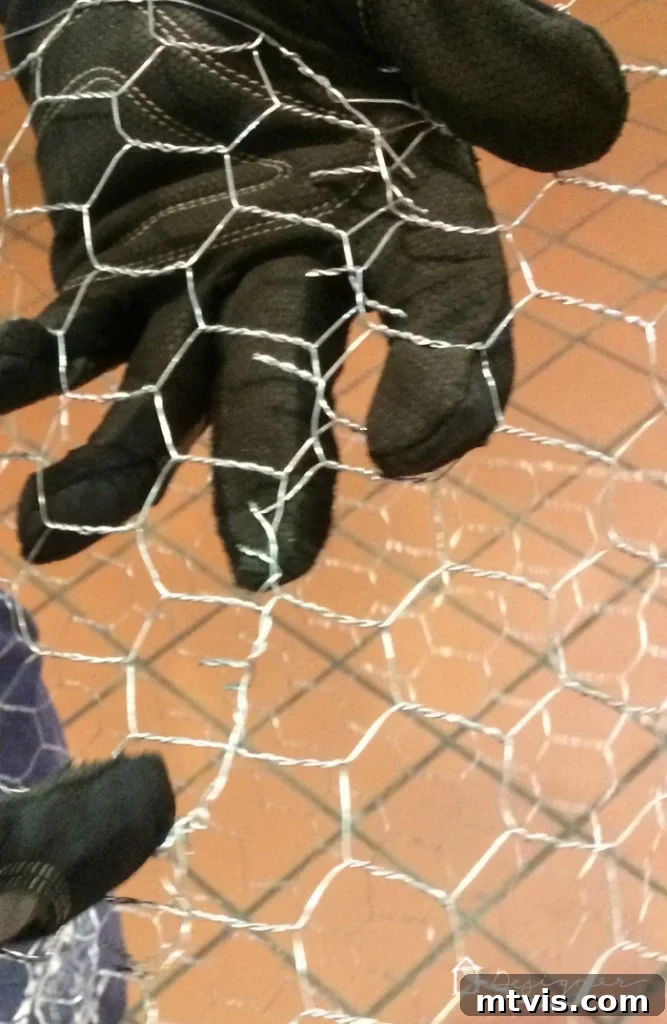 Connect chicken wire ends by twisting wires to form a tube shape for the Christmas ball base.