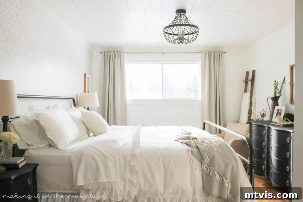 Serene farmhouse style master bedroom makeover by Making it in the Mountains, showcasing clean lines, cozy textures, and rustic charm.