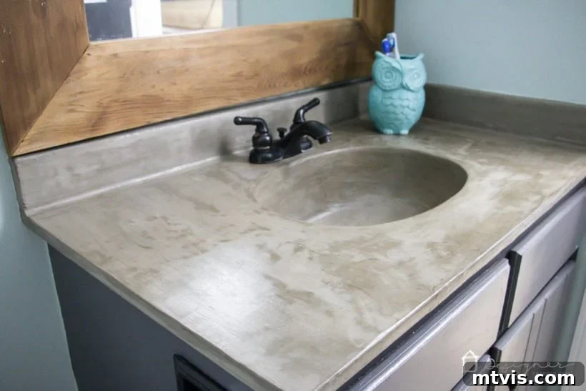 Learn how our DIY concrete vanity is holding up 18 months after completion! / DIY concrete counter top / DIY concrete sink / designertrapped.com