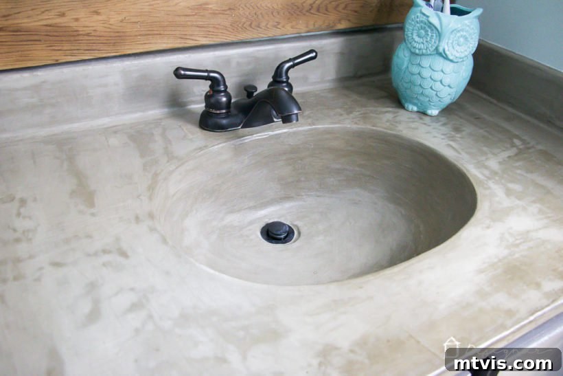 Learn how our DIY concrete vanity is holding up 18 months after completion! / DIY concrete counter top / DIY concrete sink / designertrapped.com