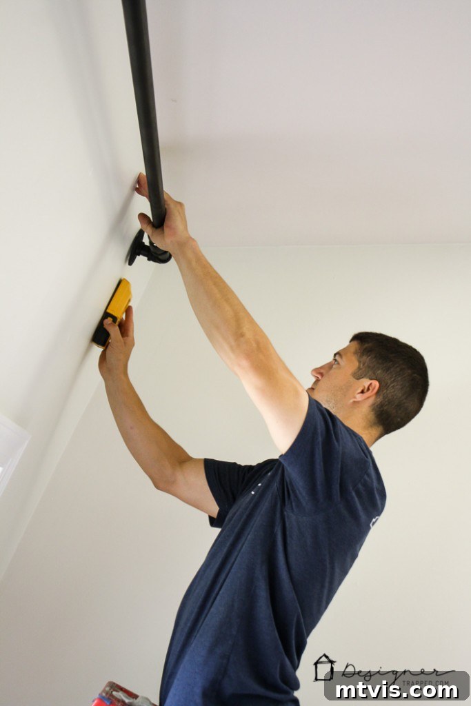 Craft Your Own Unique Curtain Rod 7 Marking drill points on the wall for DIY industrial curtain rod installation