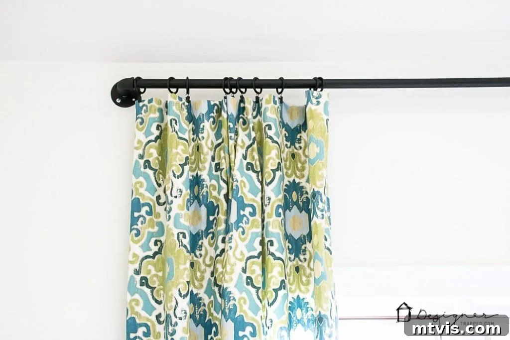 Craft Your Own Unique Curtain Rod 8 Attaching curtains to the newly installed DIY industrial pipe curtain rod