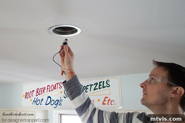 Elevate Your Lighting: Recessed to Pendant Conversion 6 Screw the new lighting harness into the existing recessed light socket.