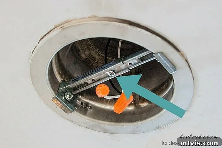 Elevate Your Lighting: Recessed to Pendant Conversion 7 Adjust and secure the cross bracing within the recessed light housing for a stable base.
