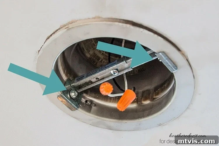 Elevate Your Lighting: Recessed to Pendant Conversion 8 Fasten the cross brace to the recessed housing using the provided screws.