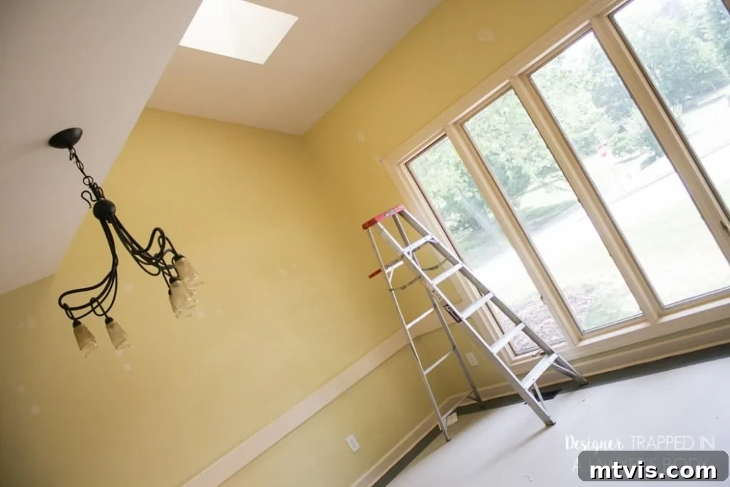 Light Up Your Space Effortlessly 3 Before image of an outdated dining room light fixture, ready to be replaced by a modern DIY pendant light.