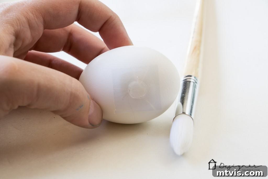 Sparkle and Spot: Creative Easter Egg Decorating 3 Applying an adhesive glue dot to a hard-boiled Easter egg