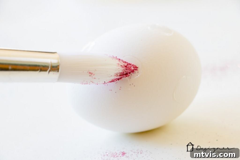 Sparkle and Spot: Creative Easter Egg Decorating 4 Using a paintbrush to cover an adhesive dot with vibrant glitter
