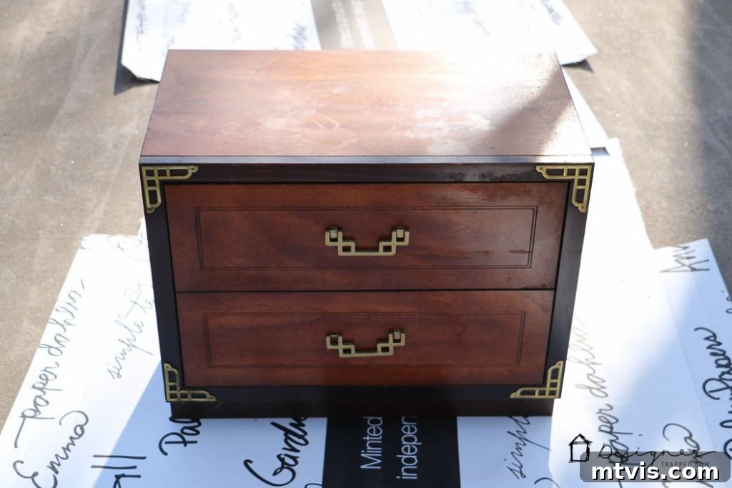 Campaign Nightstand Revival 2 Before campaign bedside table makeover, showing a worn wooden table with brass accents.