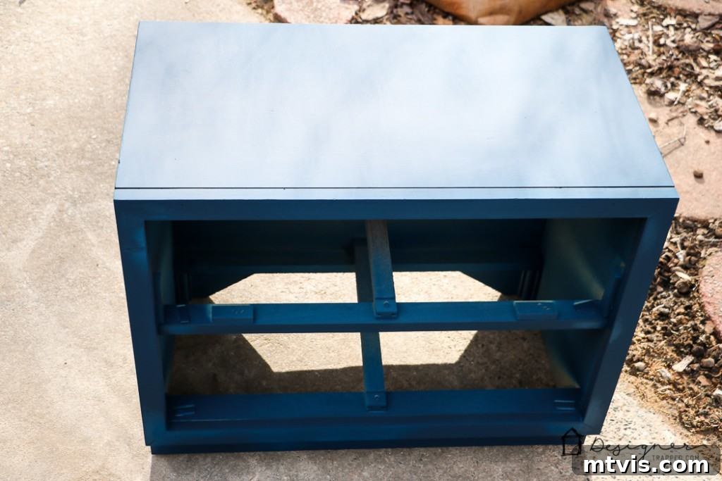 Campaign Nightstand Revival 5 Detailed shot of a campaign bedside table being painted, highlighting even coverage.