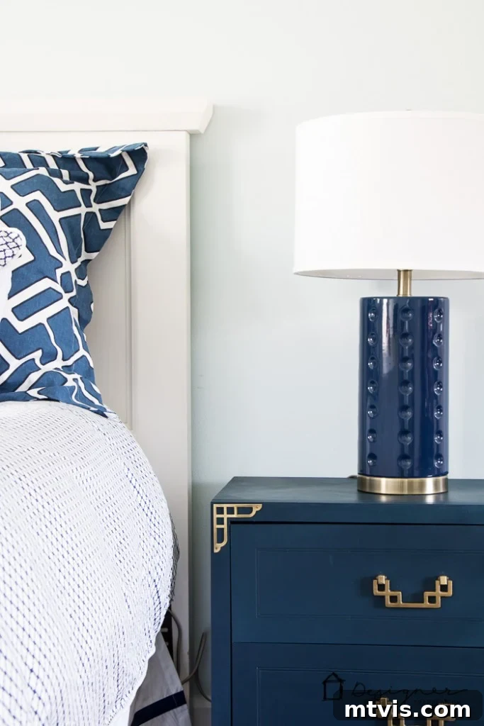 Campaign Nightstand Revival 6 Beautifully refurbished navy blue campaign bedside table with shiny brass hardware.