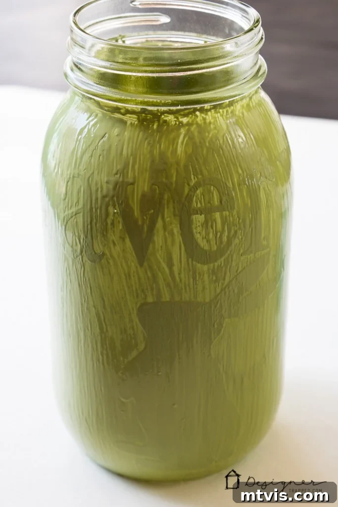 Craft Your Own Custom Mason Jars 4 A mason jar fully coated with two layers of chalk paint, completely covering the vinyl design, awaiting the final reveal.