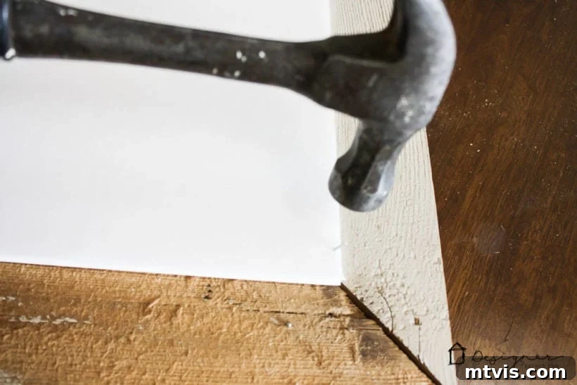 Securing mounted artwork to DIY frame with staple gun