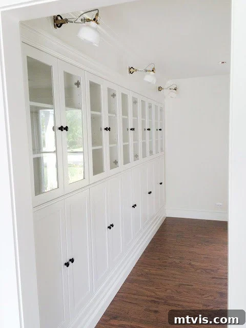 50 IKEA Hacks You Won't Believe Are IKEA 23 A pristine row of white IKEA Borgsjo bookcases, brilliantly transformed into elegant built-in shelves. The upper half features sophisticated glass doors, while the lower half boasts long, discreet cabinet doors, providing both display and concealed storage in this gorgeous DIY IKEA hack.