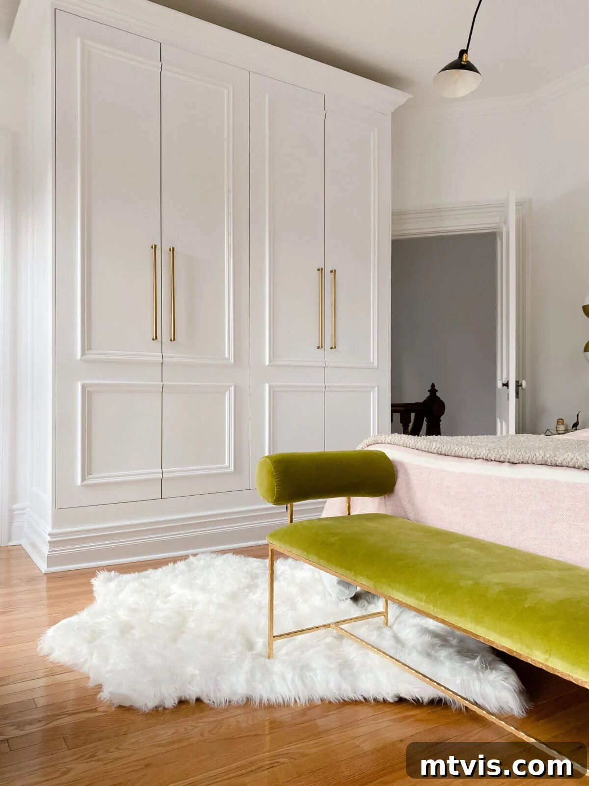 50 IKEA Hacks You Won't Believe Are IKEA 30 Two IKEA Pax wardrobes expertly transformed into custom closets within a bedroom, complemented by a serene green bench seat positioned in front of the bed. This clever hack integrates seamless storage into the room's design.