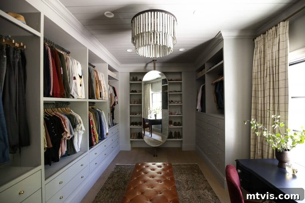 50 IKEA Hacks You Won't Believe Are IKEA 31 A spacious closet, resembling a small room, is meticulously lined with built-ins expertly crafted from IKEA Pax shelves and drawers. Clothes hang neatly from every open shelf, showcasing ample and organized storage in this dream closet design.