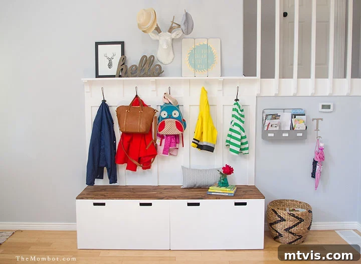 50 IKEA Hacks You Won't Believe Are IKEA 32 A mini-mudroom thoughtfully designed for children, featuring an IKEA Stuvas unit. Below sturdy hooks where coats and bags hang, a bench offers seating, with large square storage bins neatly tucked underneath, creating an organized and accessible space for kids' belongings.