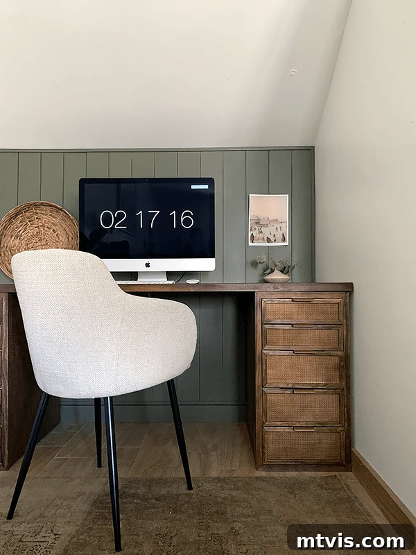 50 IKEA Hacks You Won't Believe Are IKEA 6 A compact yet stylish desk featuring a dark stained wooden surface and exquisitely caned drawers. An Apple computer monitor rests on top, complemented by a modern fabric chair positioned in front. The monitor's display shows '02 17 16', adding a touch of realism to this beautiful workspace.