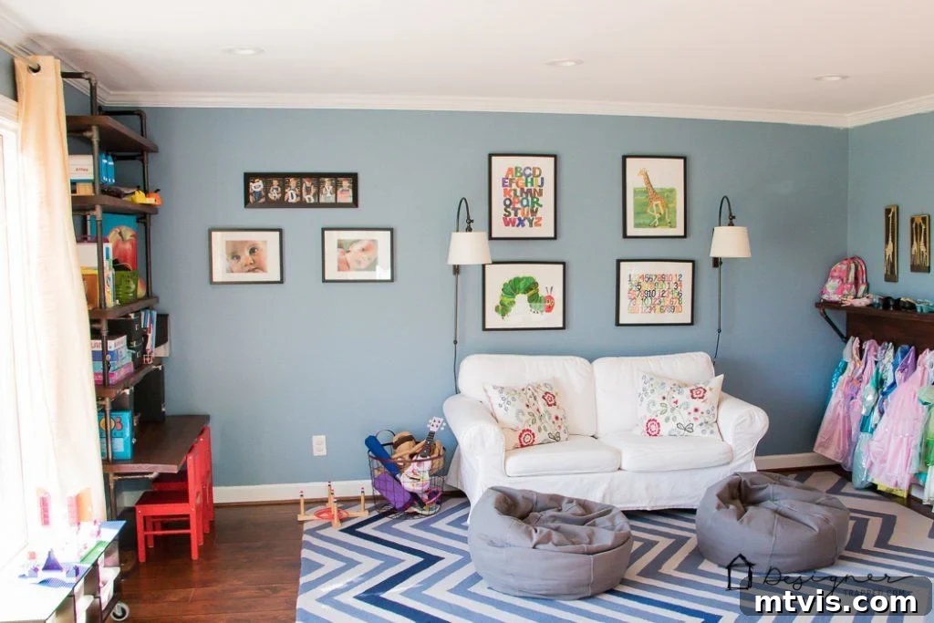 Playroom Paradise Unveiled 12 A wider view of the colorful playroom showcasing the chevron rug, grey bean bag chairs, and ample floor space for play.
