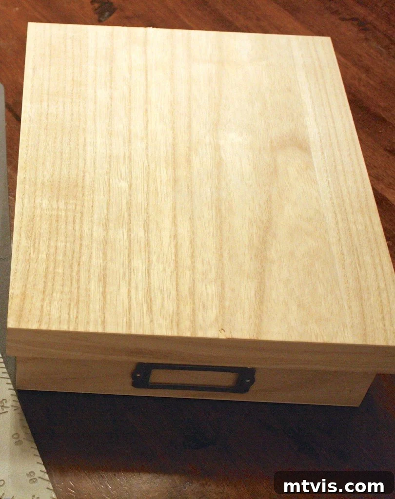 Craft Your Own Desk Organizers 4 Detailed shot of an unfinished wooden box with a cardholder, ready for customization into a DIY desk organizer tray.
