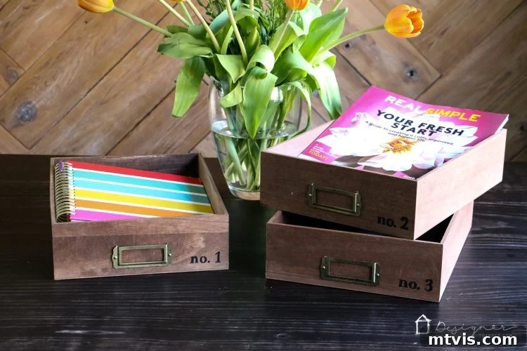 Craft Your Own Desk Organizers 7 A perfectly organized stack of three DIY Anthropologie-inspired desk organizer trays, featuring customized typography and elegant metal cardholders.