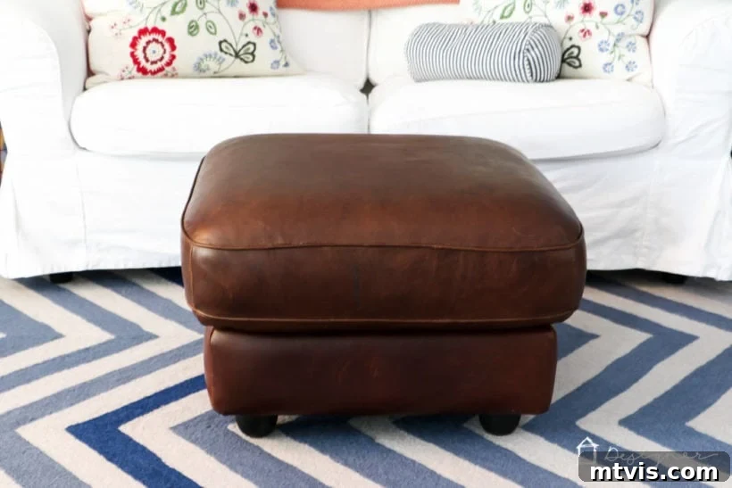 Close-up of the restored leather ottoman surface, demonstrating the effectiveness of the repair.