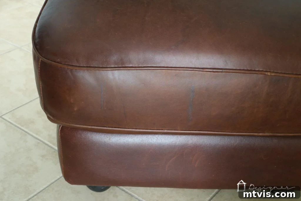 Close-up of the restored leather surface after repair, appearing smooth and rejuvenated.