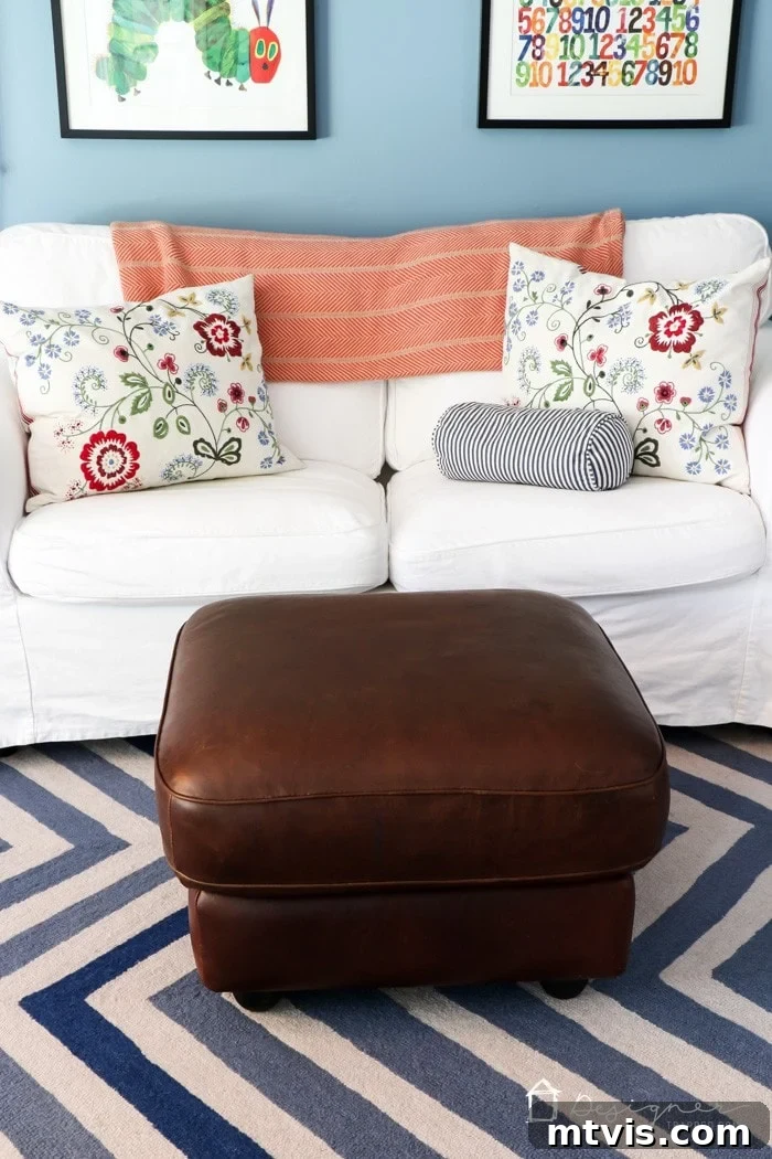 The beautifully restored leather ottoman placed in a colorful and lively playroom setting.
