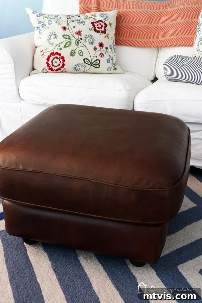 Another angle of the restored leather ottoman, highlighting its smooth, even finish.