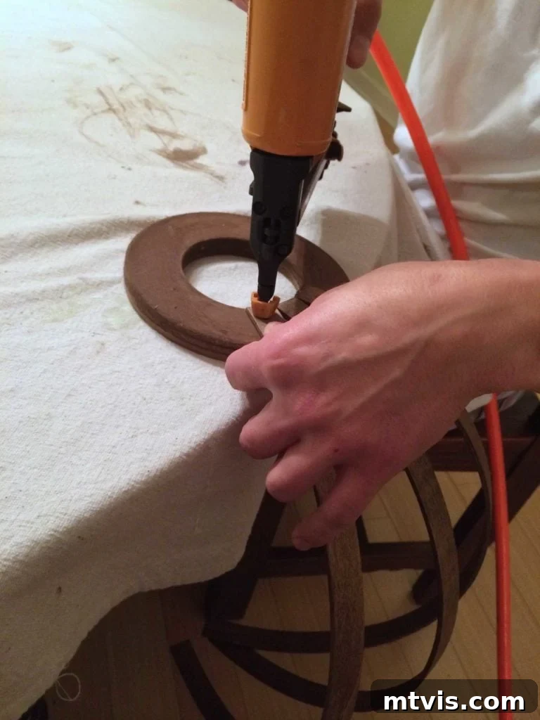 Create a High End Bentwood Pendant For Less 8 Attaching bentwood pieces to the first floral ring base with a nail gun.