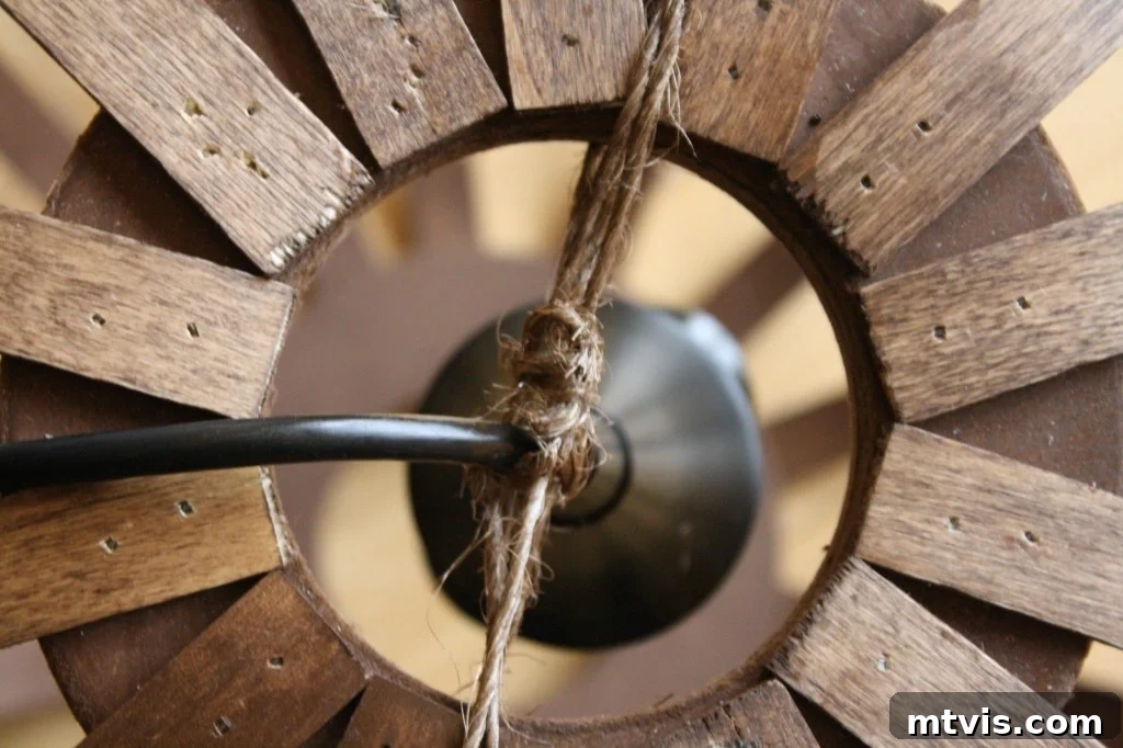 Create a High End Bentwood Pendant For Less 11 Securing the pendant light kit within the bentwood frame using stained twine.