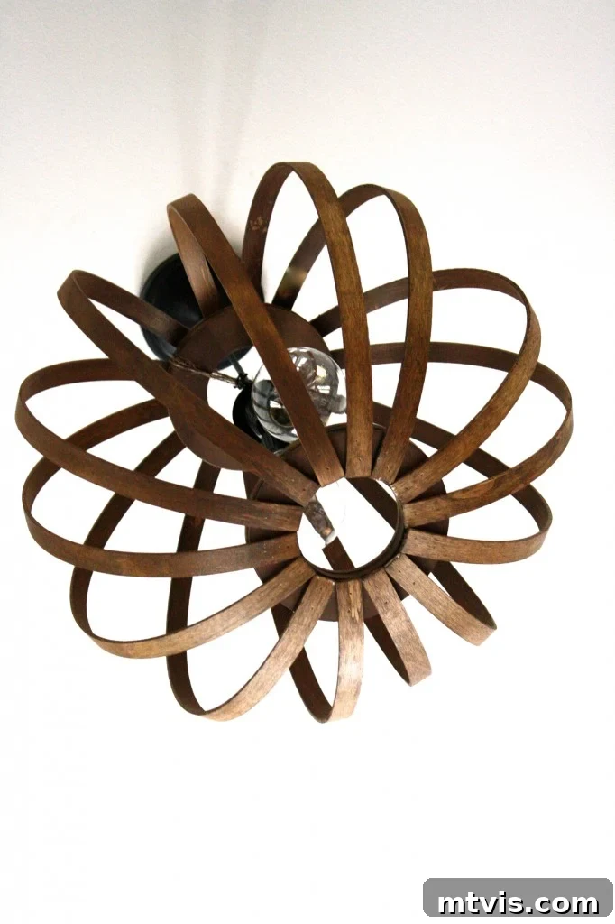 MUST PIN! Totally genius tutorial for making a West Elm Bentwood Pendant light Knock Off. Full tutorial by Designer Trapped in a Lawyer's Body. Collage of DIY home decor projects, including the West Elm Bentwood Pendant Light knockoff.