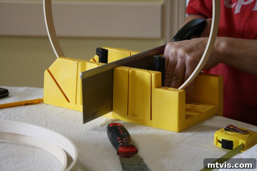 Create a High End Bentwood Pendant For Less 7 Wooden quilting hoops cut in half, preparing for the bentwood frame.