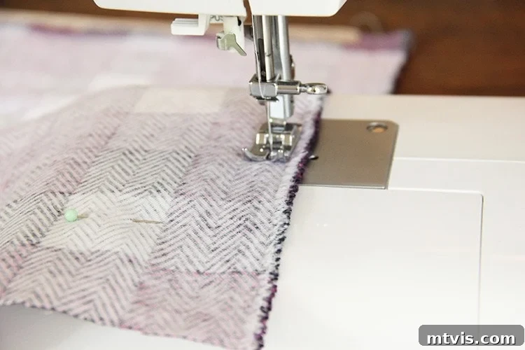 Sewing a Zippered Pillow Cover 13 Sewing machine stitching the three remaining edges of the pillow cover, with the zipper slightly open.