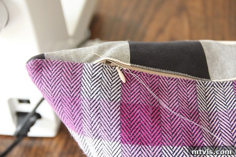 Sewing a Zippered Pillow Cover 14 Detail of hand stitching being added to the ends of the zipper for reinforcement.