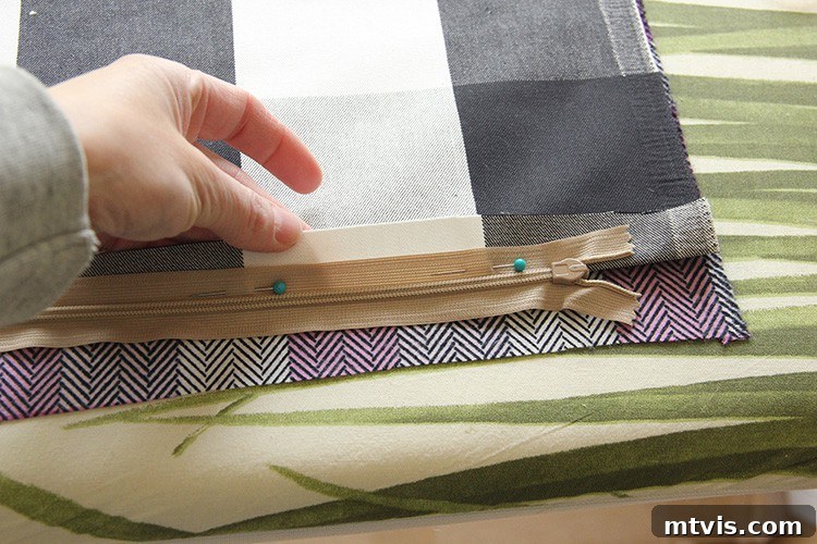 Sewing a Zippered Pillow Cover 6 A zipper being pinned to the pressed edge of fabric, ready for sewing the pillow cover.