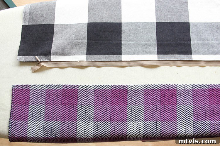 View of two fabric pieces, one already attached to the zipper, showcasing the right sides facing up.