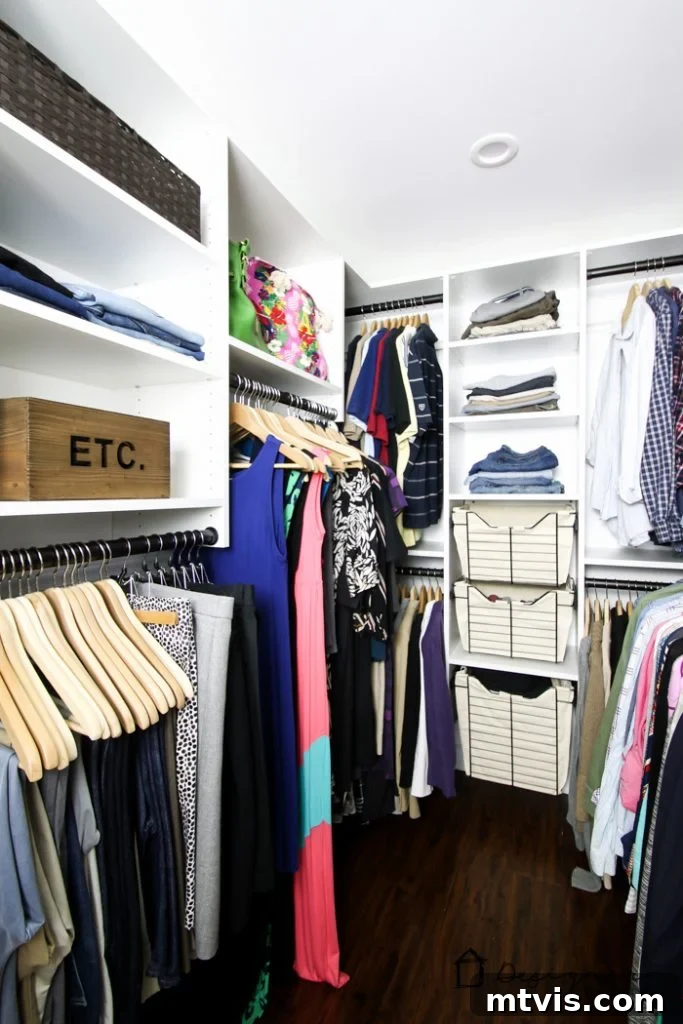DIY Closet Makeover: Obsessed with the Results! 12 A detailed view of the organized master closet, highlighting various storage solutions for hanging garments and folded items.