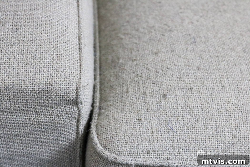 Sofa Transformation: Renew and Protect for Lasting Beauty 4 Close-up photograph of a couch cushion covered in numerous fabric pills, showcasing the worn and aged appearance of the upholstery before treatment. This emphasizes the need for a refresh. #worncouch #beforeandaftercouch