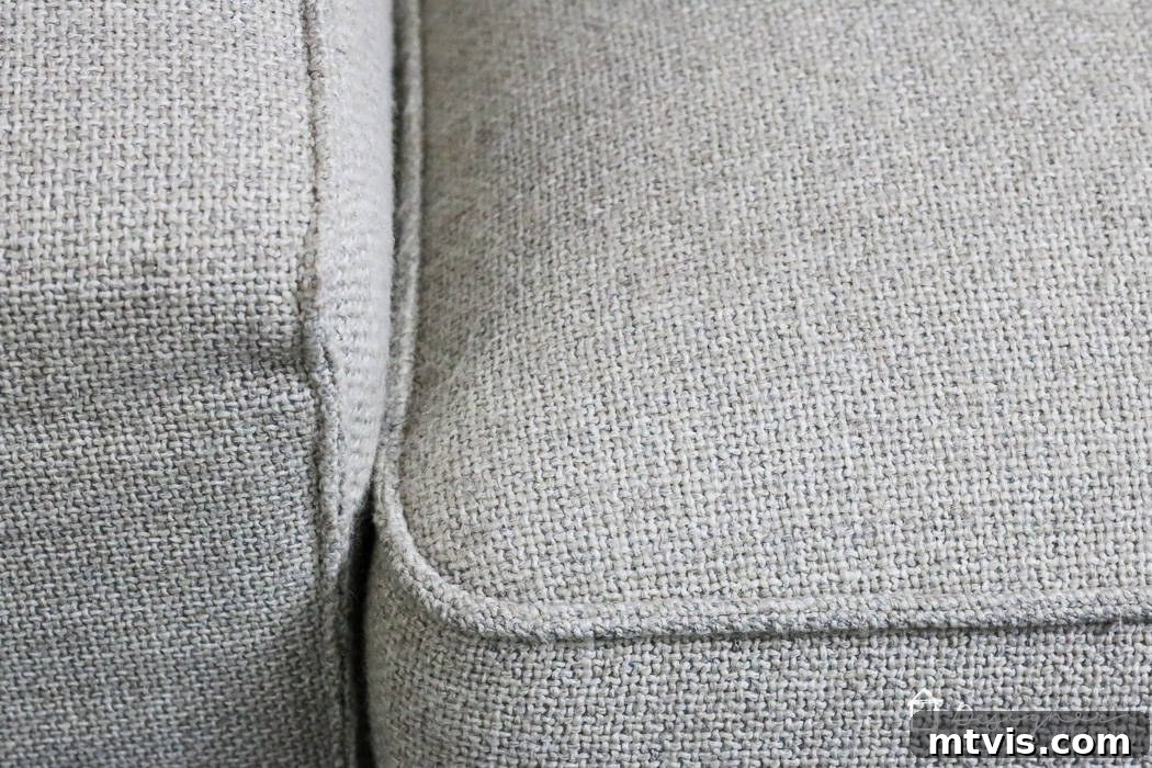 Sofa Transformation: Renew and Protect for Lasting Beauty 5 Close-up photograph of the same couch cushion after depilling and treatment, revealing a smooth, revitalized fabric surface free of pills. The 'after' shot highlights the success of the makeover. #couchafter #renewedfurniture