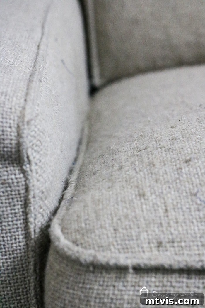 Sofa Transformation: Renew and Protect for Lasting Beauty 6 Full shot of a living room couch visibly affected by fabric pilling across its cushions and armrests, illustrating its tired condition prior to the restoration project. #oldsofa #homedecorbefore
