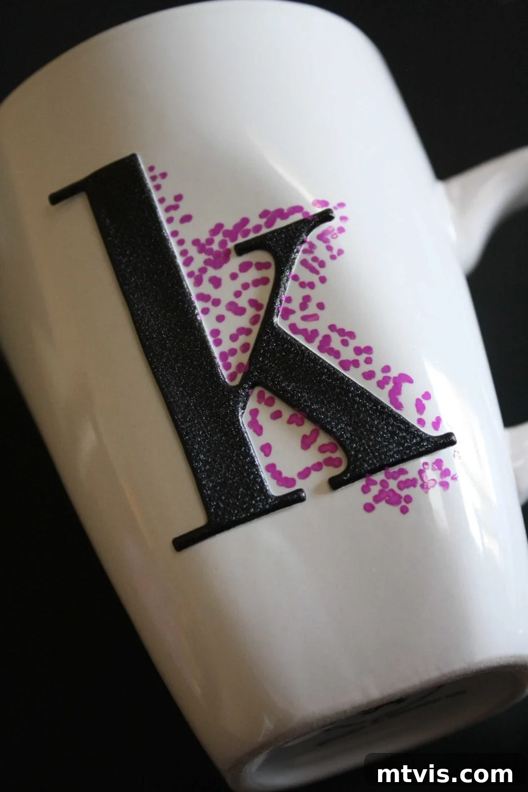 Playful Dotted Sharpie Mugs 3 A closeup of a white mug with a dimensional "K" craft sticker with purple Sharpie dots beginning to surround it.