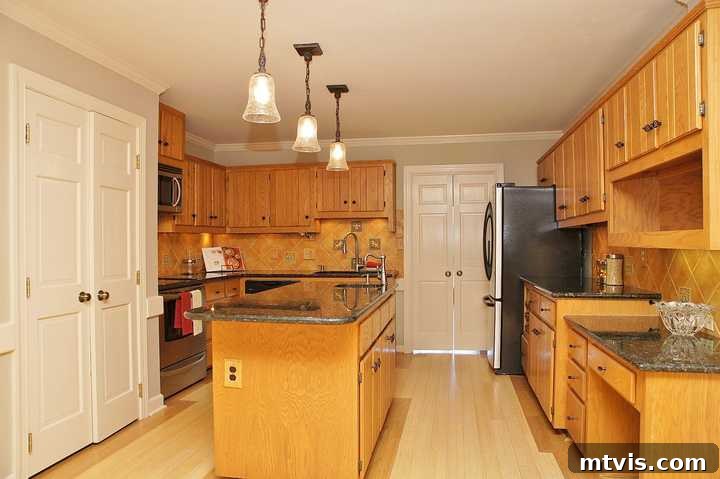 DIY Drama Black Doors White Trim 2 A before picture of a plain, old wooden kitchen with an island and outdated cabinets.