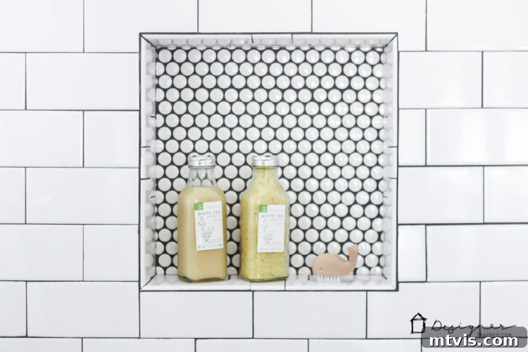 Detailed shot of the shower interior, highlighting the functional and aesthetic choices made during the DIY bathroom remodel, including the elegant tile work.