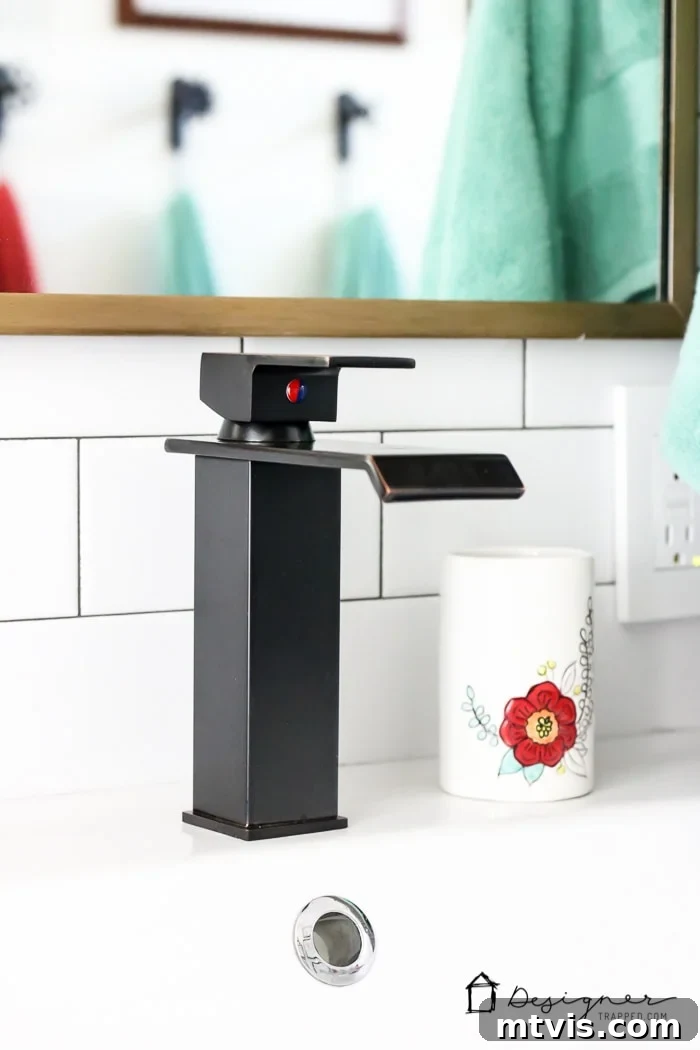 Close-up on the stylish yet budget-friendly faucets and custom gold-finished mirrors, showcasing how small DIY details elevate the entire bathroom remodel.
