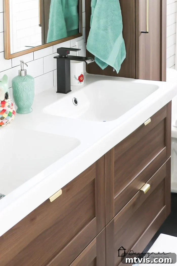 A close-up of the vanity area in the DIY bathroom remodel, highlighting the chosen hardware and its seamless integration with the modern cabinetry.