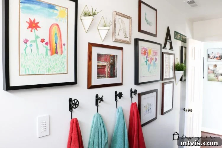 A vibrant art gallery wall featuring children's art and budget-friendly prints, alongside geometric wall vases with air plants, adding personal charm to the DIY bathroom.