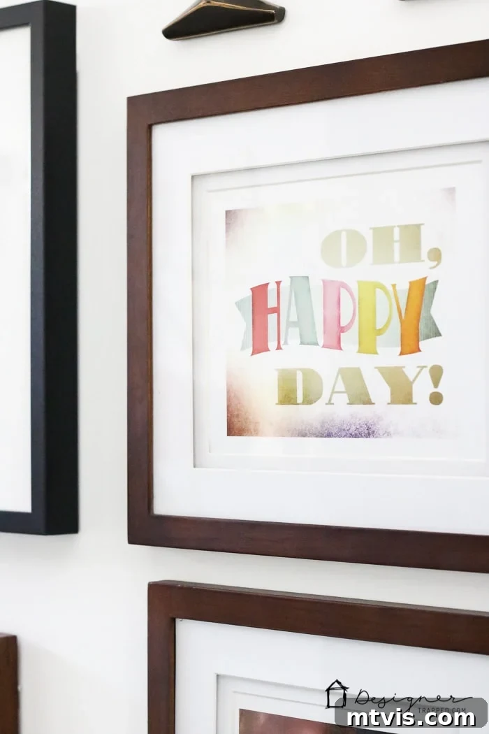 Showcasing the unique decor elements on the gallery wall, from framed art to hanging greenery, all contributing to the fresh and inviting look of the DIY bathroom.